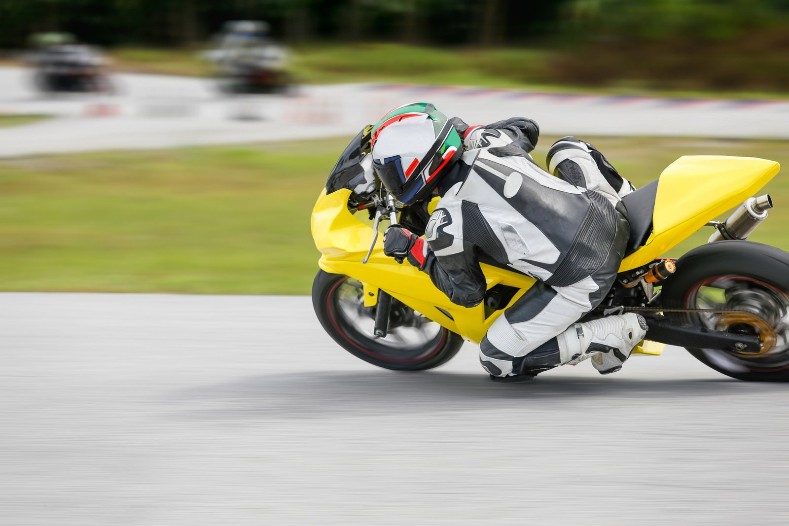 Motorcycle practice leaning into a fast corner on track